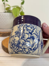 Load image into Gallery viewer, #015 - 16 oz. Blue hydrangea patterned mug with purple rim *see notes
