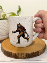 Load image into Gallery viewer, #008 - 16 oz. White speckled mug with Bigfoo t with a flannel and Beer *see notes