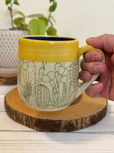 Load image into Gallery viewer, #001 - 16 oz. Green cactus patterned mug with blue inside and yellow rim
