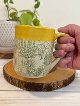 Load image into Gallery viewer, #002 - 16 oz. Green cactus patterned mug with blue inside and yellow rim
