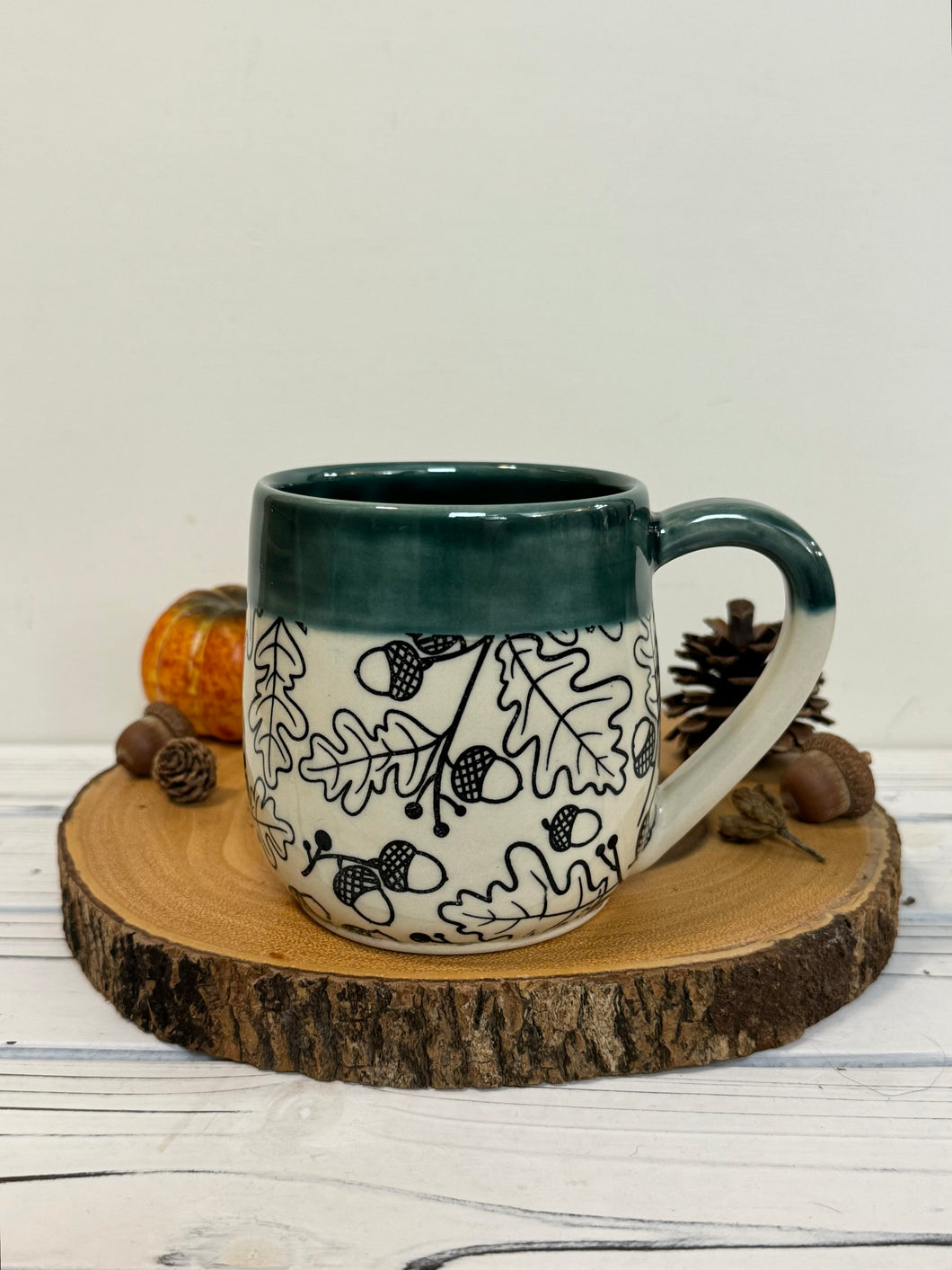 #010 -  18 oz. Black Acorn pattern mug with green rim