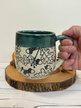 Load image into Gallery viewer, #010 -  18 oz. Black Acorn pattern mug with green rim
