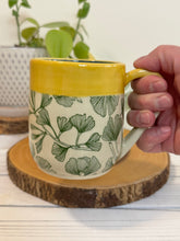 Load image into Gallery viewer, #003 - 16 oz. Green ginkgo patterned mug with blue inside and yellow rim
