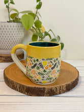 Load image into Gallery viewer, #004 - 14 oz. Coloured floral patterned mug with green inside and yellow rim
