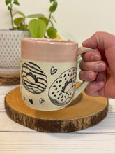 Load image into Gallery viewer, #022 - 16 oz. Doughnut and heart patterned mug with pink rim
