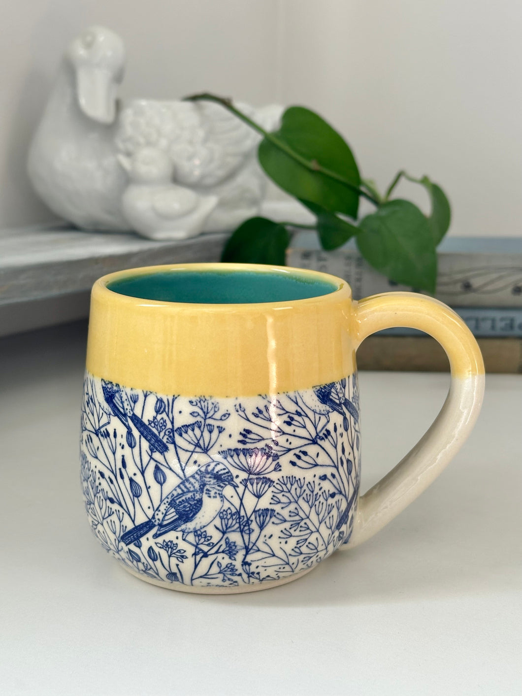 #002 - 14-16 oz. Birds in blue mug with yellow rim and turquoise inside *see notes