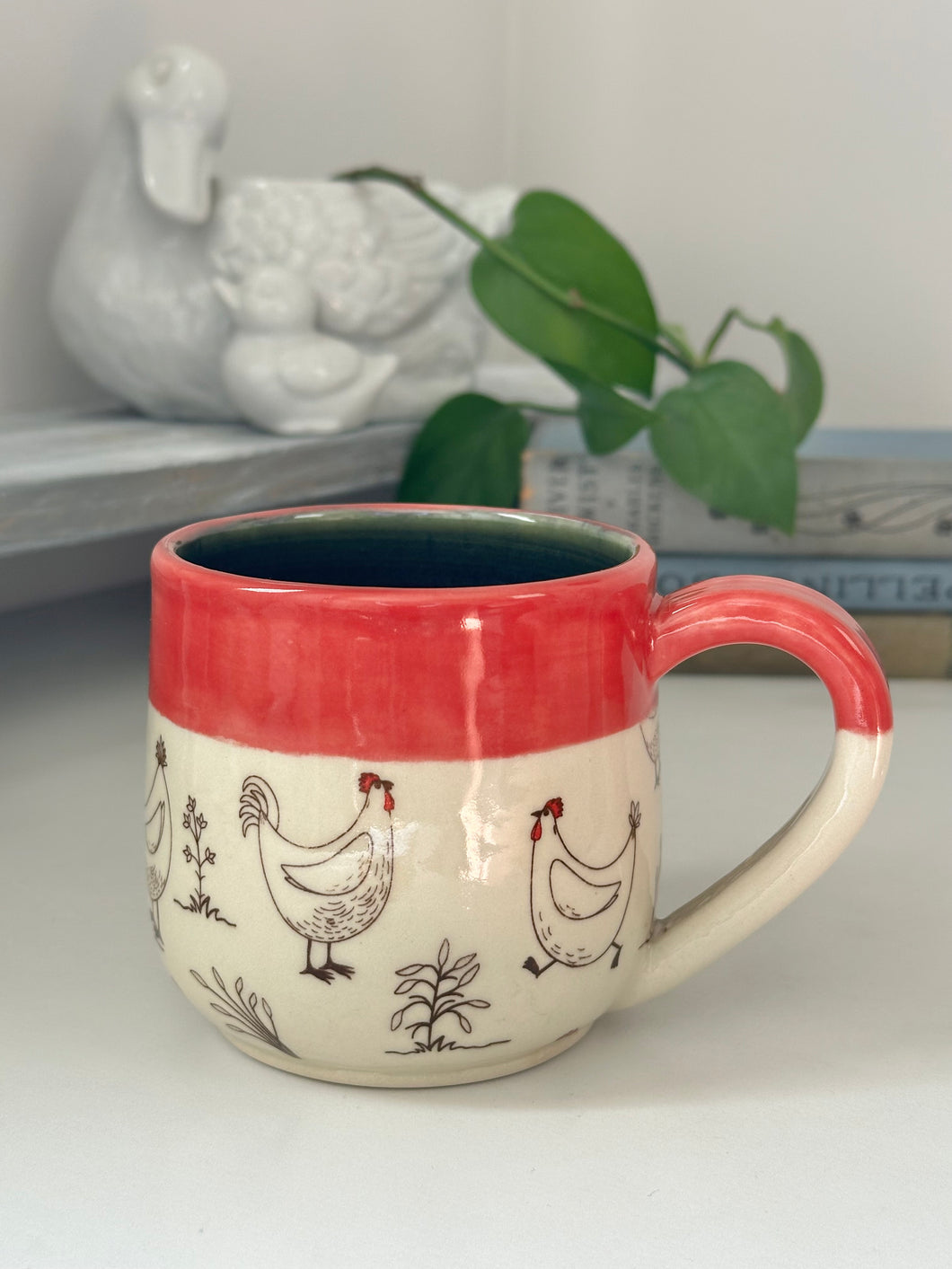 #004 - 14 oz. white Chicken mug with red rim and dark blue inside