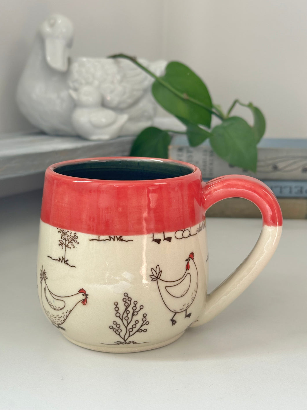 #005 - 16 oz. white Chicken mug with red rim and dark blue inside