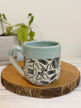 Load image into Gallery viewer, #001 - 16 oz. Yarn patterned mug with aqua rim and inside
