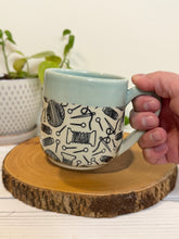 Load image into Gallery viewer, #001 - 16 oz. Yarn patterned mug with aqua rim and inside
