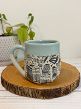 Load image into Gallery viewer, #003 - 16 oz. Book patterned mug with aqua rim and inside
