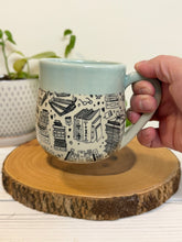 Load image into Gallery viewer, #003 - 16 oz. Book patterned mug with aqua rim and inside
