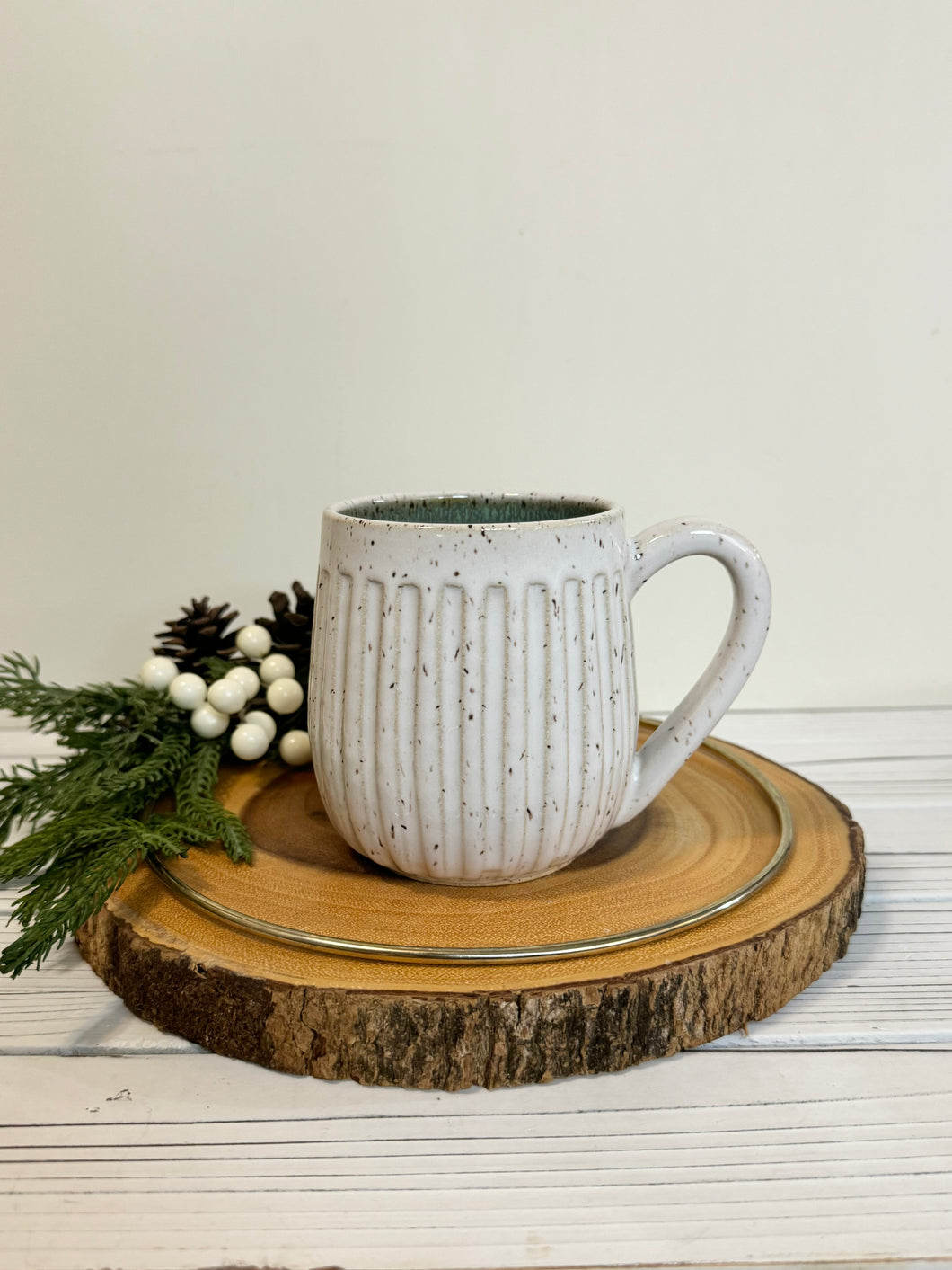 #028 - 14 oz. White speckled carved mug with green inside