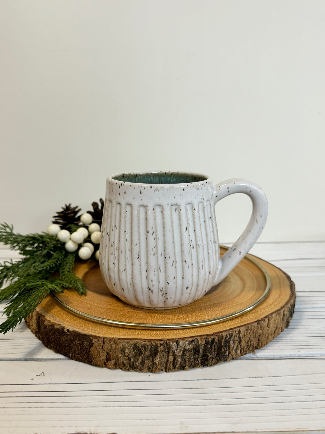 #029 - 16 oz. White speckled carved mug with green inside