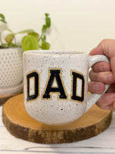 Load image into Gallery viewer, #006 - 16 oz. White speckled mug with black DAD
