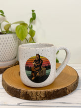 Load image into Gallery viewer, #007 - 16 oz. White speckled mug with Bigfoot drinking coffee
