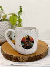 Load image into Gallery viewer, #007 - 16 oz. White speckled mug with Bigfoot drinking coffee
