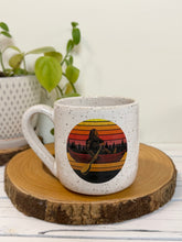 Load image into Gallery viewer, #009 - 18 oz. White speckled mug with Bigfoot in a canoe
