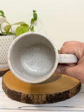 Load image into Gallery viewer, #009 - 18 oz. White speckled mug with Bigfoot in a canoe
