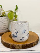 Load image into Gallery viewer, #023 - 16 oz. White speckled mug with whales and shells
