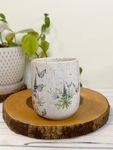 Load image into Gallery viewer, #028 - 14 oz. White speckled mug with watering can and flowers
