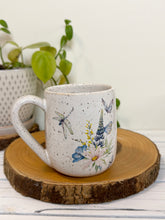 Load image into Gallery viewer, #028 - 14 oz. White speckled mug with watering can and flowers
