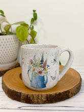 Load image into Gallery viewer, #029 - 16 oz. White speckled mug with watering can and flowers
