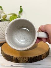 Load image into Gallery viewer, #029 - 16 oz. White speckled mug with watering can and flowers
