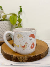 Load image into Gallery viewer, #030 - 16 oz. White speckled mug with gardening designs
