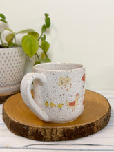 Load image into Gallery viewer, #030 - 16 oz. White speckled mug with gardening designs

