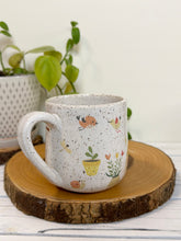 Load image into Gallery viewer, #031 - 16 oz. White speckled mug with gardening designs
