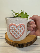 Load image into Gallery viewer, #012 - 16 oz. White speckled mug with a stand out carved matte pink heart *see note
