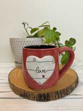 Load image into Gallery viewer, #011 - 16 oz. Red mug with love pattern on a stand out white Matte heart. Black inside *see note
