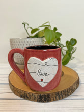 Load image into Gallery viewer, #011 - 16 oz. Red mug with love pattern on a stand out white Matte heart. Black inside *see note
