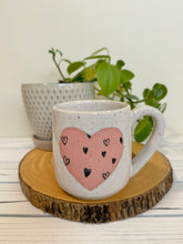 Load image into Gallery viewer, #014 - 16 oz. White speckled mug with heart pattern on matte pink heart
