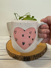 Load image into Gallery viewer, #014 - 16 oz. White speckled mug with heart pattern on matte pink heart
