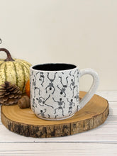 Load image into Gallery viewer, #004 - 16 oz. Skeleton patterned white speckled mug with black inside
