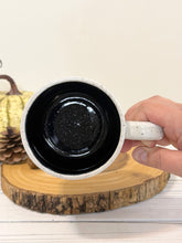Load image into Gallery viewer, #006 - 16 oz. Ghost patterned white speckled mug with black inside
