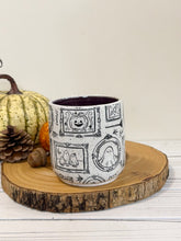 Load image into Gallery viewer, #007 - 16 oz. Ghost patterned white speckled mug with dark purple inside
