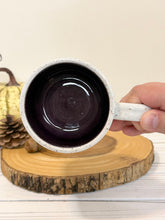 Load image into Gallery viewer, #007 - 16 oz. Ghost patterned white speckled mug with dark purple inside
