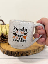 Load image into Gallery viewer, #013 - 16 oz. Sweater weather on white speckled mug
