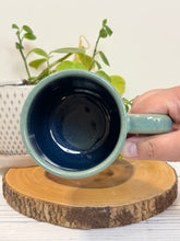Load image into Gallery viewer, #022 - 16 oz. Mountain Cabin mug with green glaze (pattern on bare clay) and blue inside
