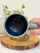 Load image into Gallery viewer, #023 - 16 oz. Mountains are calling mug with green glaze (pattern on bare clay) and blue inside
