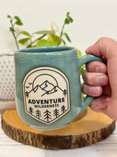 Load image into Gallery viewer, #024 - 16 oz. Adventure wilderness mug with green glaze (pattern on bare clay) and blue inside
