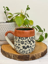 Load image into Gallery viewer, #025 - 16 oz. Autumn patterned mug with burnt orange rim and blue inside

