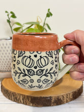 Load image into Gallery viewer, #025 - 16 oz. Autumn patterned mug with burnt orange rim and blue inside
