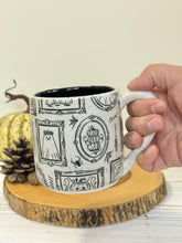 Load image into Gallery viewer, #001 - 16 oz. White speckled mug with Halloween ghost patterns. Black inside. * See notes
