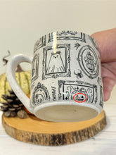 Load image into Gallery viewer, #001 - 16 oz. White speckled mug with Halloween ghost patterns. Black inside. * See notes
