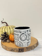Load image into Gallery viewer, #002 - 16 oz. White speckled mug with Halloween ghost patterns. Black inside. * See notes
