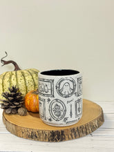 Load image into Gallery viewer, #003 - 16 oz. White speckled mug with Halloween ghost patterns. Black inside.
